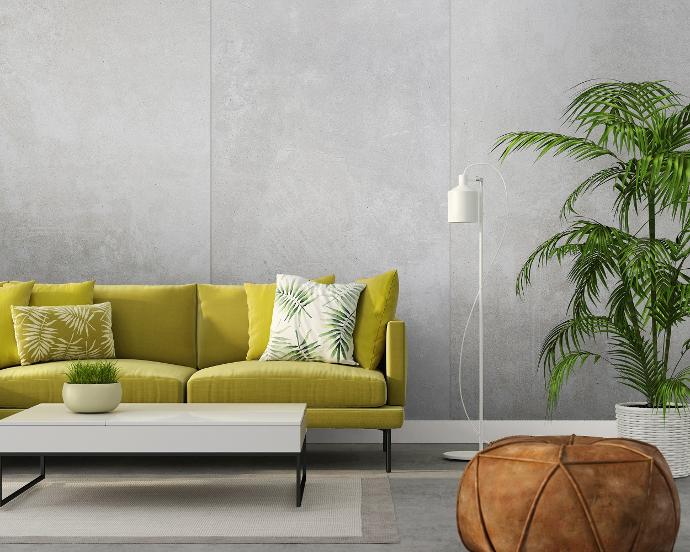 A bright and inviting living room featuring lightweight concrete panels. The panels provide a clean and modern aesthetic, perfectly complementing the vibrant furnishings and decor.